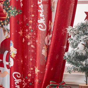 Detail of red Christmas curtain with Santa and snowflake prints in a festive room setup