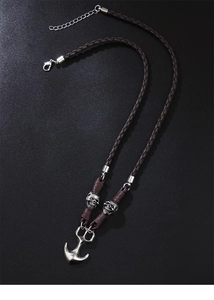 Detail of woven brown leather necklace featuring silver skull beads and an anchor pendant