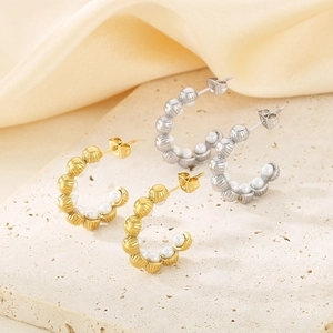 Fashionable C-shaped shell pearl earrings with 18K gold plated texture on stone surface