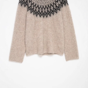 Oatmeal knit alpaca sweater with classic Fair Isle pattern around the round neckline