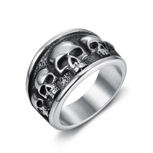 Nordic punk style stainless steel ring with continuous skull relief patterns on white background
