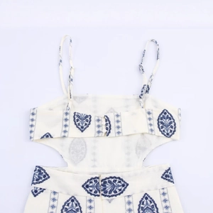 Women's backless midi dress with blue floral embroidery and halter neck design