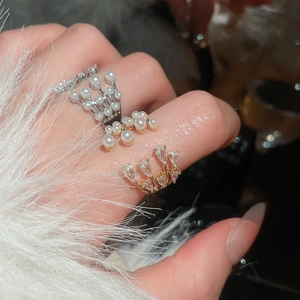Macro view of French vintage layered pearl ring with zircon accents on a model's hand