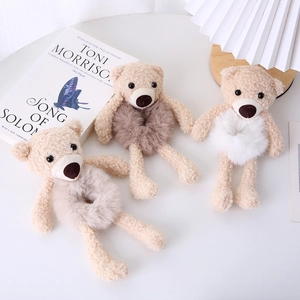 Cute plush bear elastic hair bands in white and brown colors on a bright table