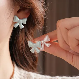 French vintage acrylic bow stud earrings in pastel blue and pink with pearly finish