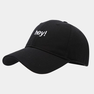 Detail of white hey embroidery on a black cotton twill baseball cap with curved brim