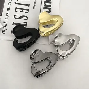 Irregular heart-shaped metal hair claws in gold, silver, black, and grey finishes