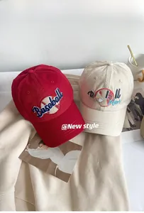 Detailed embroidery of Baseball Mom text on cotton caps with soft lifestyle background