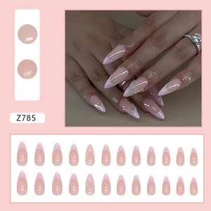 Pink French almond press-on nails with pearl accents and elegant long pointed shape