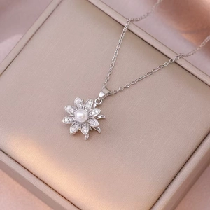 Elegant silver flower necklace with pearl and zircon pendant on a luxury gift box