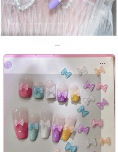 Detailed view of candy-colored resin bow charms applied to various DIY manicure designs