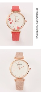 Close-up of classic retro watches with floral dials and embossed leather straps for women