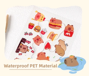 Detail of waterproof PET stickers featuring Capybara and fast food themes on white paper