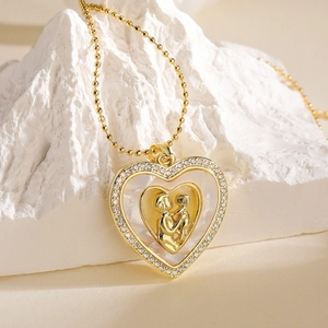 Gold heart necklace with mother and child relief and white zirconia circle