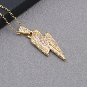 Macro view of gold lightning bolt pendant necklace with micro-pave cubic zirconia crystals