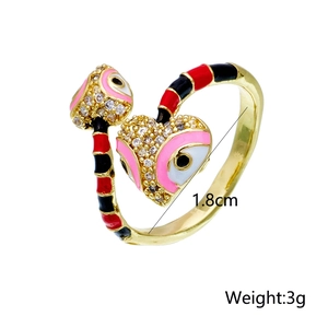 Detail view of double-headed snake open ring with enamel pattern and micro-set zircon heart