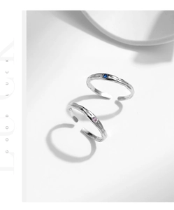 Detailed shot of 925 sterling silver rings with tin foil texture and blue pink gemstones