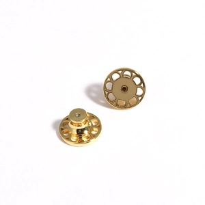 Golden pin backs with ornate cutout design and secure clutch for earrings or brooches