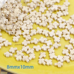 Macro shot of 8x10mm white turquoise stone cross beads for DIY jewelry making