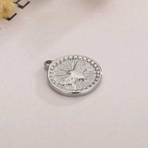 Detailed macro of a silver round stainless steel charm with embossed bee and beaded edge