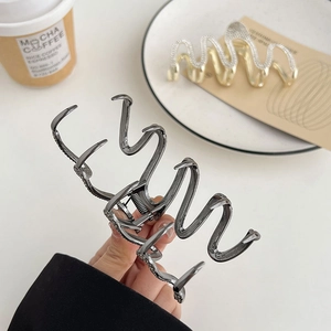 Elegant gold rhinestone and gunmetal wave claw clips for thick hair styling