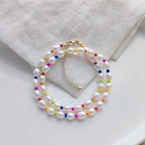 Detail of bohemian layered necklace with freshwater pearls and colorful seed beads