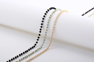 Detailed view of faceted glass bead sunglasses chains in black, blue and champagne gold