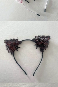 Close-up of black lace cat ear headband with red texture details and anti-slip tips