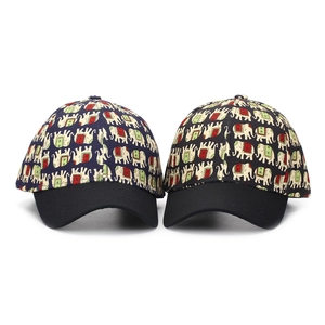 Detailed view of two ethnic elephant print baseball caps in navy blue and black colors