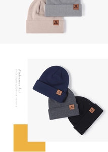 Detailed knit texture and brown leather label on various color options of the beanie
