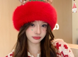 Close-up of red plush Christmas hat with brown antlers and thick fuzzy texture on a model