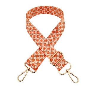 Adjustable wide replacement bag strap with orange floral print and gold metal buckles