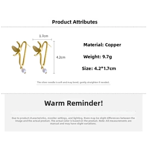 Detail view of gold flower earrings with pearls showing 4.2cm by 1.7cm product dimensions