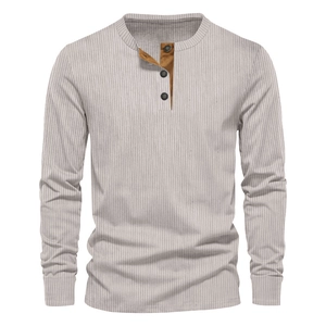 Close-up of ribbed texture and brown contrast placket on men's corduroy Henley shirt