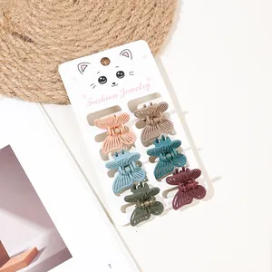 Set of 6 colorful matte butterfly mini hair claws on a fashion jewelry display card