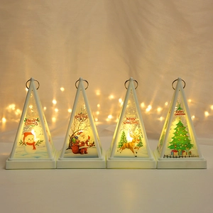 Set of four white LED Christmas lanterns with festive prints and metal hanging rings