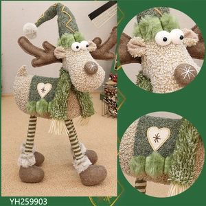 Detail of plush reindeer ornament featuring striped long legs and a heart snowflake patch