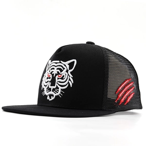 Close-up of black trucker hat featuring white tiger head and red scratch embroidery details