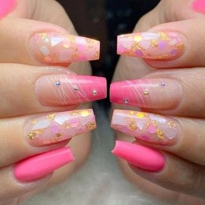 Pink coffin press-on nails featuring glitter accents and delicate rhinestone line art