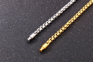 Detailed macro view of gold and silver box chains with cylindrical plug-in connectors