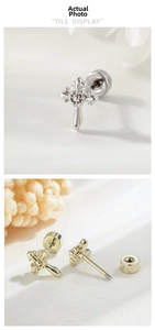 Macro detail of cross stud earrings with fine embossed texture and secure screw-back design