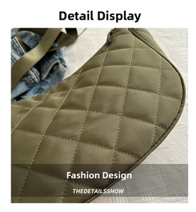 Close-up of olive green quilted dumpling bag showing nylon texture and diagonal stitching