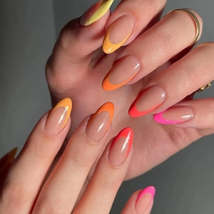 Long almond press-on nails with neon French gradient tips in yellow and orange