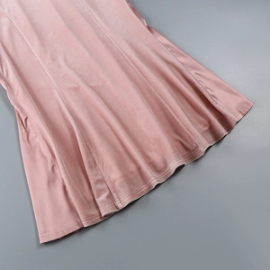 Detail of pink velvet dress hem showing soft texture and premium double-stitched edges