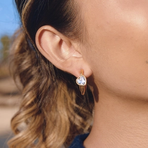 Elegant gold-plated heart-shaped zircon C-hoop earrings on a model in natural light