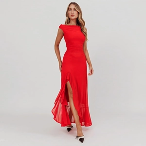 Detail view of red sleeveless dress with side slit, ruched fabric, and asymmetrical hem