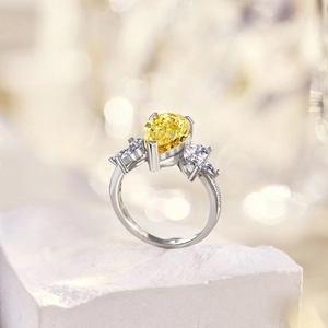 Macro shot of S925 silver ring featuring pear-cut yellow zircon and marquise side stones