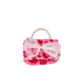 Pink plush kids handbag with faux pearl handle and large sequined bow decoration
