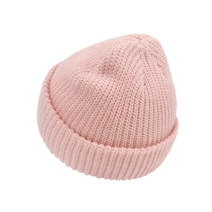Close-up of pink knitted beanie showing ribbed texture and folded brim for infants