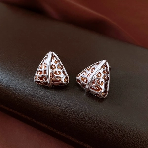 Macro shot of 14K gold plated triangular leopard print earrings with hollow metal pattern